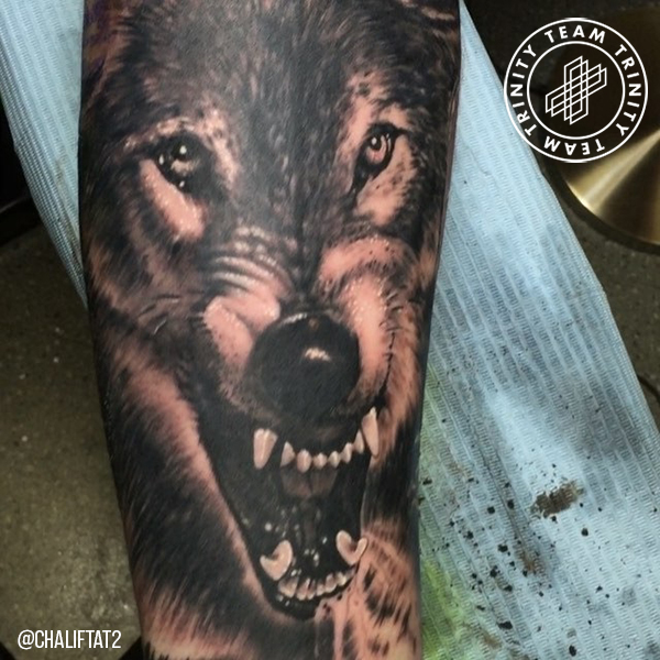 black and grey wolf face tattoo